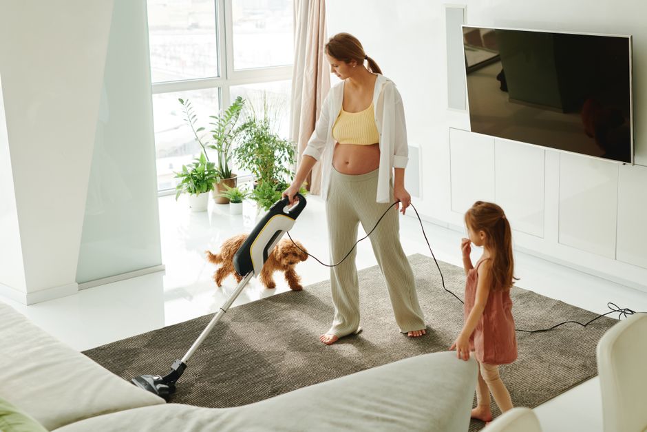 Vacuuming a bright living room floor with precision